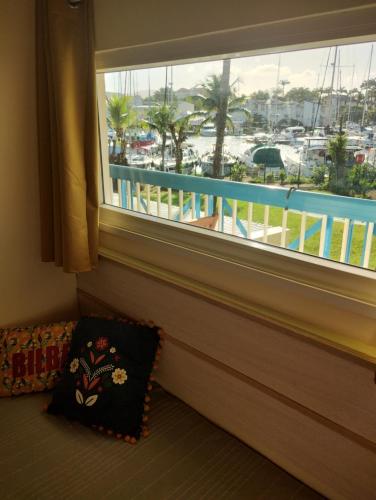 a window in a room with a view of a marina at Charmant T1 avec vue sur marina in Les Trois-Îlets