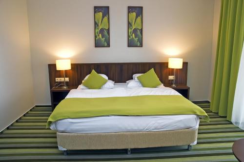 En eller flere senger på et rom på Hotel Ginkgo