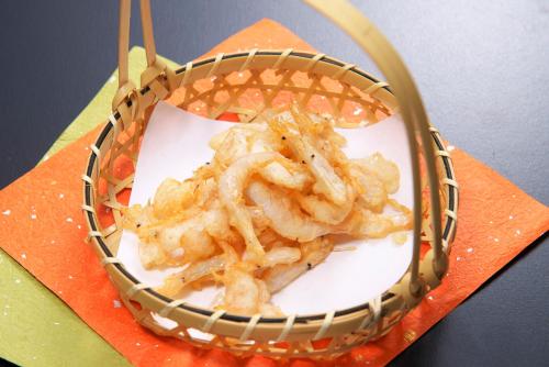 a basket full of shrimp on a plate with chopsticks at Hotel Hotaka in Takayama