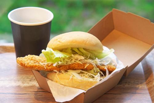 a sandwich in a box next to a cup of coffee at Hotel Hotaka in Takayama
