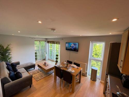 a living room with a couch and a table at Contemporary, Stylish Apartment in Weston in Worle