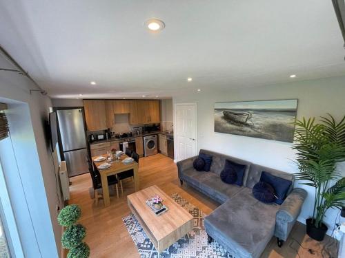 a living room with a couch and a table at Contemporary, Stylish Apartment in Weston in Worle