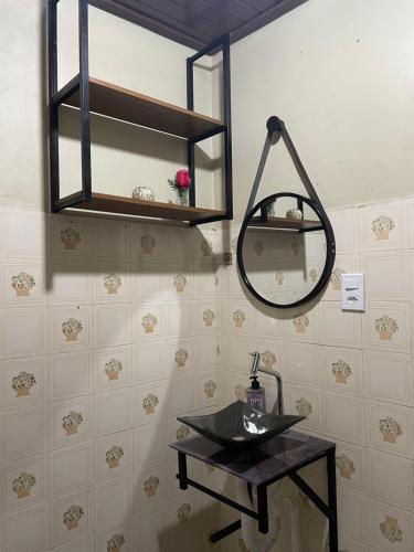 a bathroom with a black sink and a mirror at Chalé Rute Bilby Alter Do Chão in Santarém