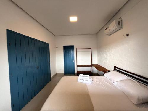 a bedroom with a bed and a blue door at Casa Refúgio de Galos in Galos