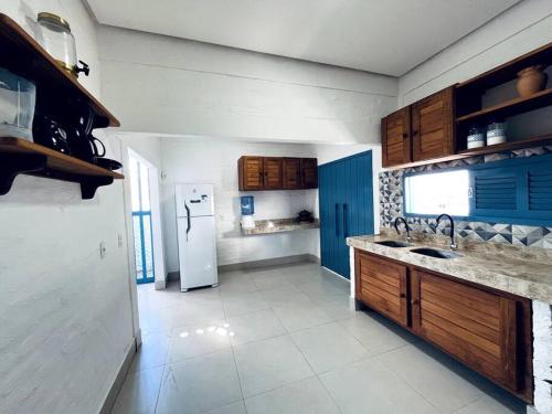 a kitchen with a refrigerator and a sink at Casa Refúgio de Galos in Galos