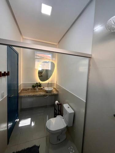 a bathroom with a white toilet and a mirror at Casa Refúgio de Galos in Galos