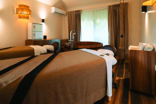 a hotel room with two beds and a bathroom at Hotel Shibari - Restaurant & Cenote Club in Tulum