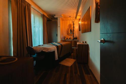 a hotel room with a bathroom with a sink and a room at Hotel Shibari - Restaurant & Cenote Club in Tulum