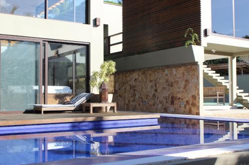 a house with a swimming pool next to a building at MARESIAS alto luxo Reveillon 2026 in Maresias