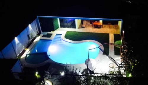 an overhead view of a swimming pool at night at Home La Fortuna in Fortuna