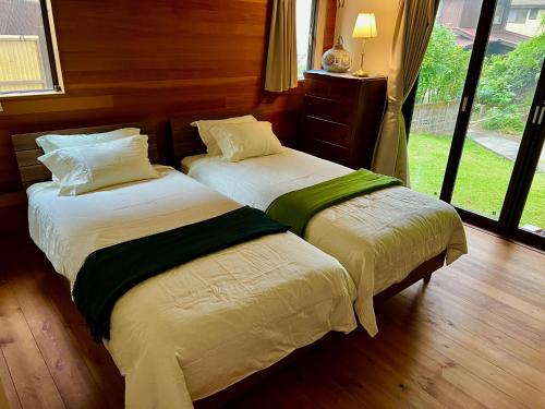 two beds sitting next to each other in a bedroom at 極楽寺邸 - Gokurakuji House in Kamakura