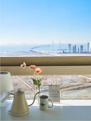 a vase of flowers sitting on a table next to a window at The November Stay In landmark in Incheon