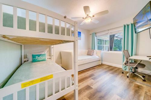 a bedroom with two bunk beds and a desk at Palm Lagoon Clearwater - 3 bedroom Resort House with heated pool & SPA in Clearwater