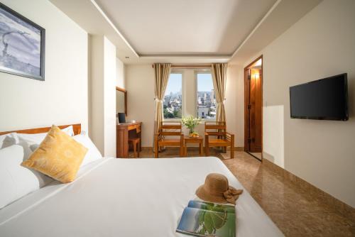 a hotel room with a bed with a teddy bear on it at Titan Hotel Da Nang in Danang