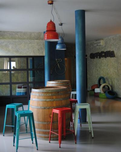 a room with colorful stools and a barrel at Hotel Panorama in Cambiano