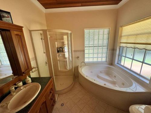 a large bathroom with a large tub and a shower at Oasis of Hope - Main House in Upper Orara