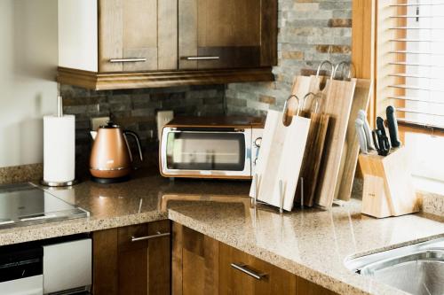 a kitchen with a counter top with a microwave at Monterey House by SANA in Tateyama