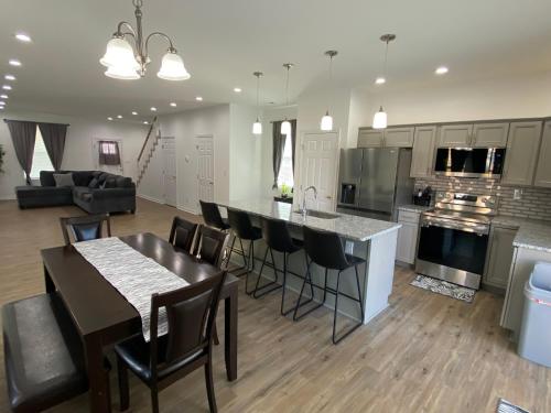 a kitchen and living room with a table and chairs at The Chesapeake Gray in Norfolk