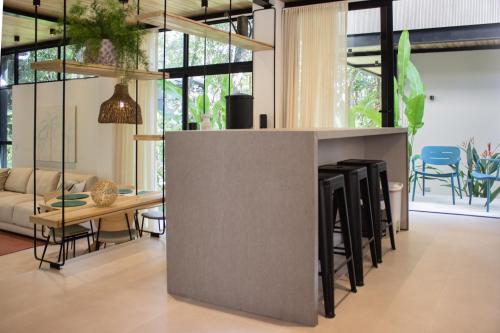 a kitchen and living room with a table and chairs at D'Palm Villas in Puntarenas