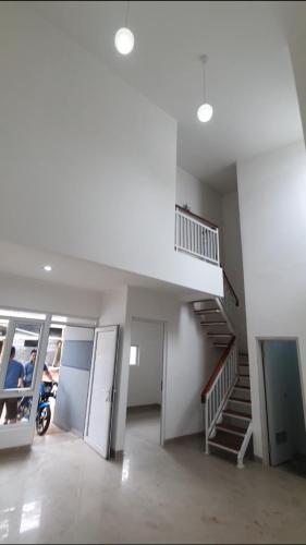 a room with a staircase and a motorcycle in it at Disewakan Rumah minimalis 2 lantai Prestige 2 Sawangan in Depok