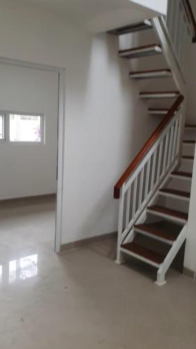 an empty room with a staircase in a house at Disewakan Rumah minimalis 2 lantai Prestige 2 Sawangan in Depok