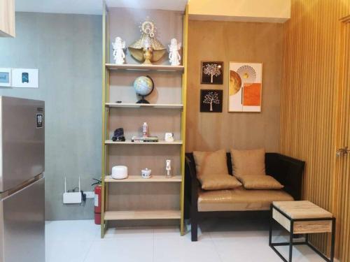 a room with a shelf with items on it at Naga City Stylish Condo in Naga