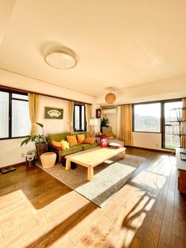 a living room with a couch and a table at 池袋新宿涩谷三地埼京线9分至16分直达 可住2人至10人 星の園 in Tokyo