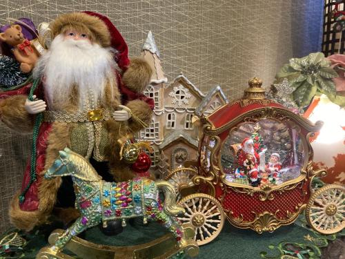 a santa claus figurine next to a gold carriage at Ryoso Chatani in Kyoto