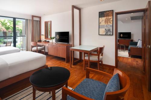 a hotel room with a bed and a desk at Woodlands Suites Serviced Residences - SHA Extra Plus in Pattaya North