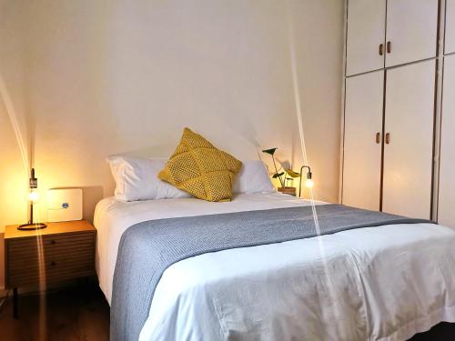 a bedroom with a bed with two lamps on a table at 28 on Ryneveld in Stellenbosch
