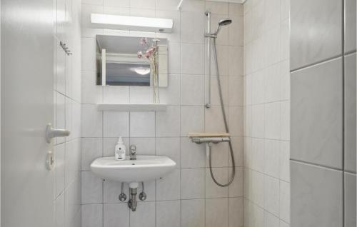 a white bathroom with a sink and a shower at Nice Apartment In Allinge With Wifi in Sandvig