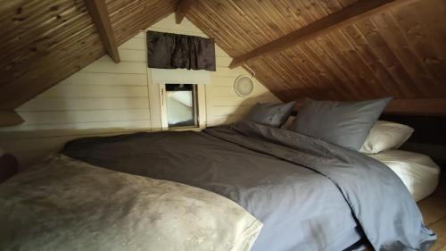 a bedroom with a large bed in a attic at Saviaugu majake Põlvamaal in Kärsa