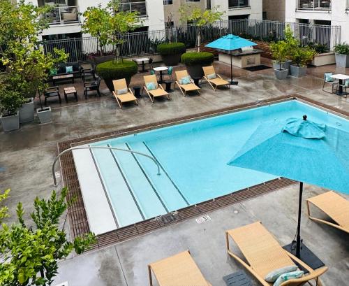 an overhead view of a pool with chairs and umbrellas at The Clouds in Los Angeles