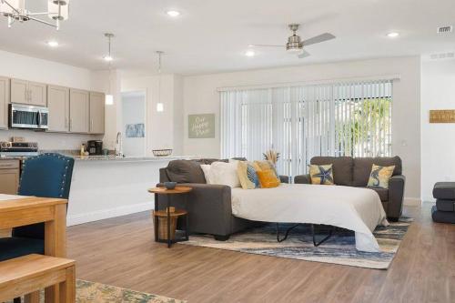 a living room with a couch and a kitchen at Luxury King Suite, 3BR 2BA, Beach Vibe, Top-Tier Amenities, Prime location in Palm Coast
