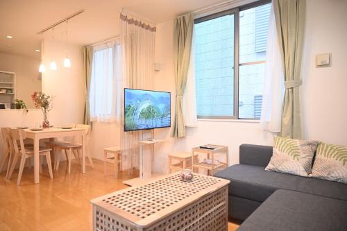 a living room with a couch and a table at Mi-Villa Pure Gray in Tokyo