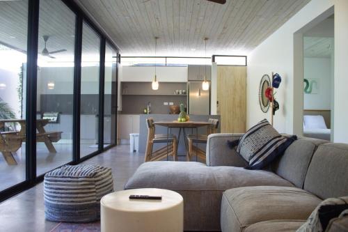 a living room with a couch and a table at D'Palm Villas in Puntarenas