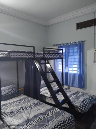 a couple of bunk beds in a room at Vimeanz @Bohemiaz in Kampot