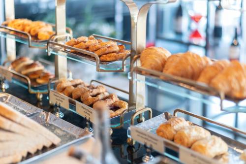 a bunch of pastries on display in a bakery at Woodlands Suites Serviced Residences - SHA Extra Plus in Pattaya North