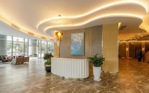 a lobby with a reception desk in a building at Panorama Nha Trang Signature in Nha Trang