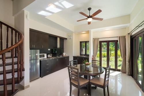 a kitchen and dining room with a table and chairs at Banyu Biru Villa in Lagoi