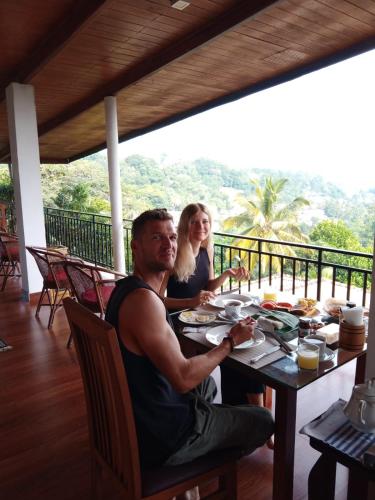 a man and a woman sitting at a table at The Tenthola in Kandy