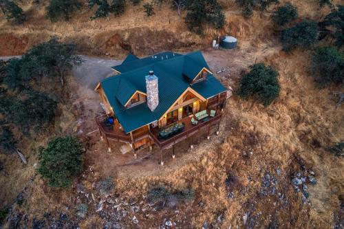 an overhead view of a house with a green roof at 4 Kings Log Cabin 150 Acres Spectacular Views in Three Rivers
