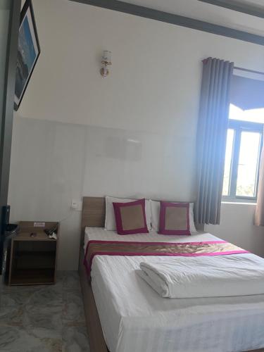 a bedroom with two beds and a window at Lak village in Lien Son