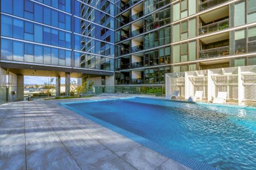 a swimming pool in front of a building at Grand Central Towers Apt Resort-Style Amenities - Hosted by CanStay in Phillip