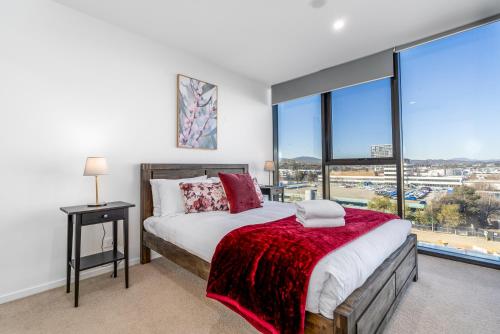 a bedroom with a bed and a large window at Grand Central Towers Apt Resort-Style Amenities - Hosted by CanStay in Phillip
