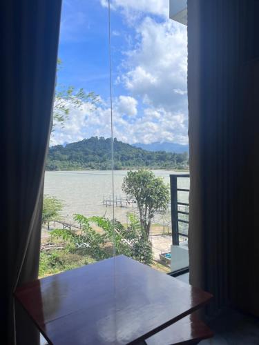 a room with a window with a view of a river at Lak village in Lien Son