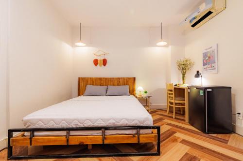 a bedroom with a bed and a desk at Pasteur Home 3 in Ho Chi Minh City