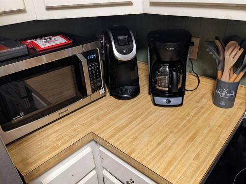 a counter with a microwave and a coffee maker on it at Evergreen Escape At Snowshoe in Snowshoe