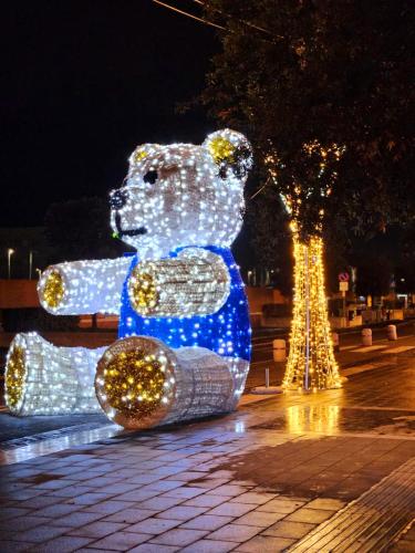 a teddy bear statue is lit up with lights at la Dimora del Borgo in Fiumicino