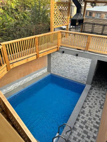 uma pequena piscina com um deque de madeira e água azul em V.MOD Hotel em Yerevan